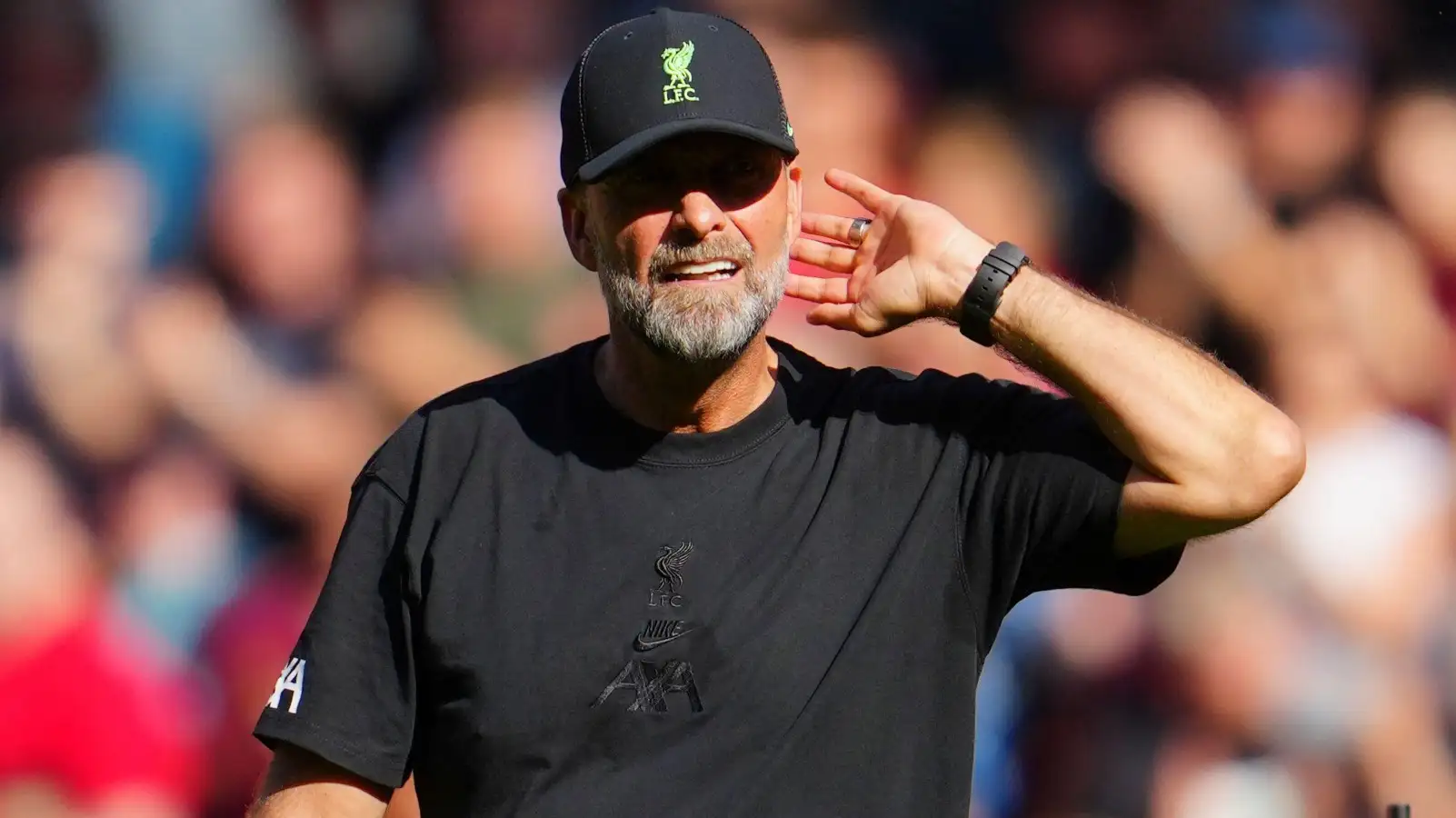 Jurgen Klopp mugs his ear to Liverpool supporters after a win.