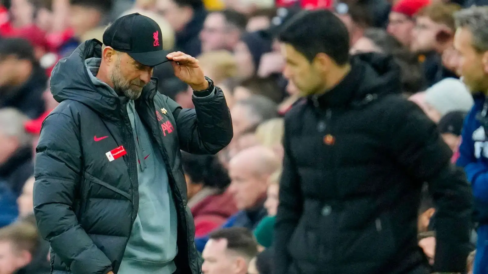 Liverpool employer Jurgen Klopp, through Installation preceptor Mikel Arteta in the foreground