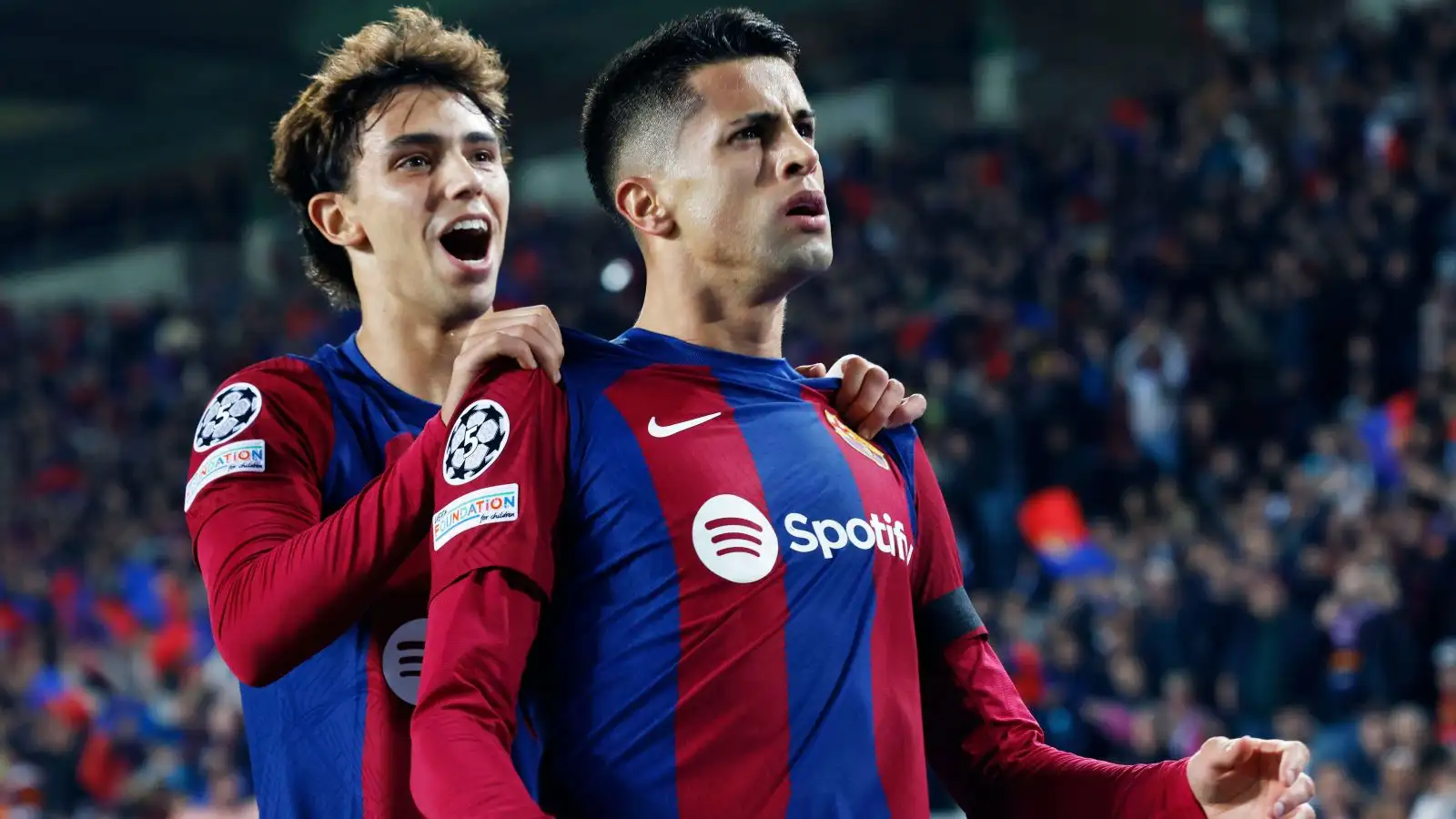 Barcelona players Joao Cancelo and also Joao Felix announce joy a goal.