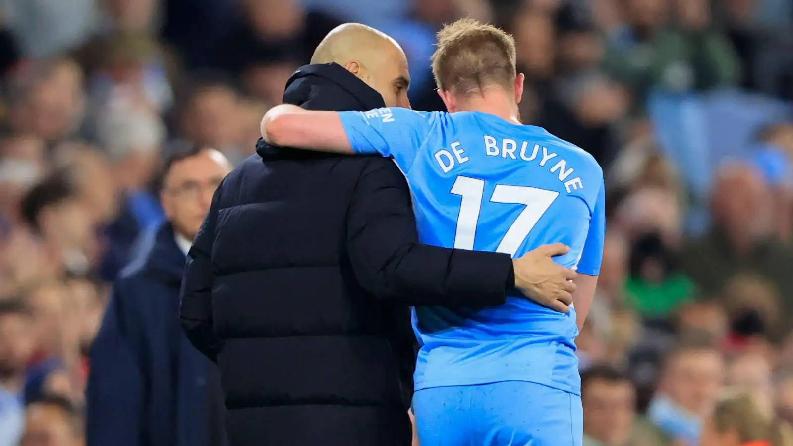 Man City manager Pep Guardiola hugs Kevin De Bruyne after he comes off the pitch.