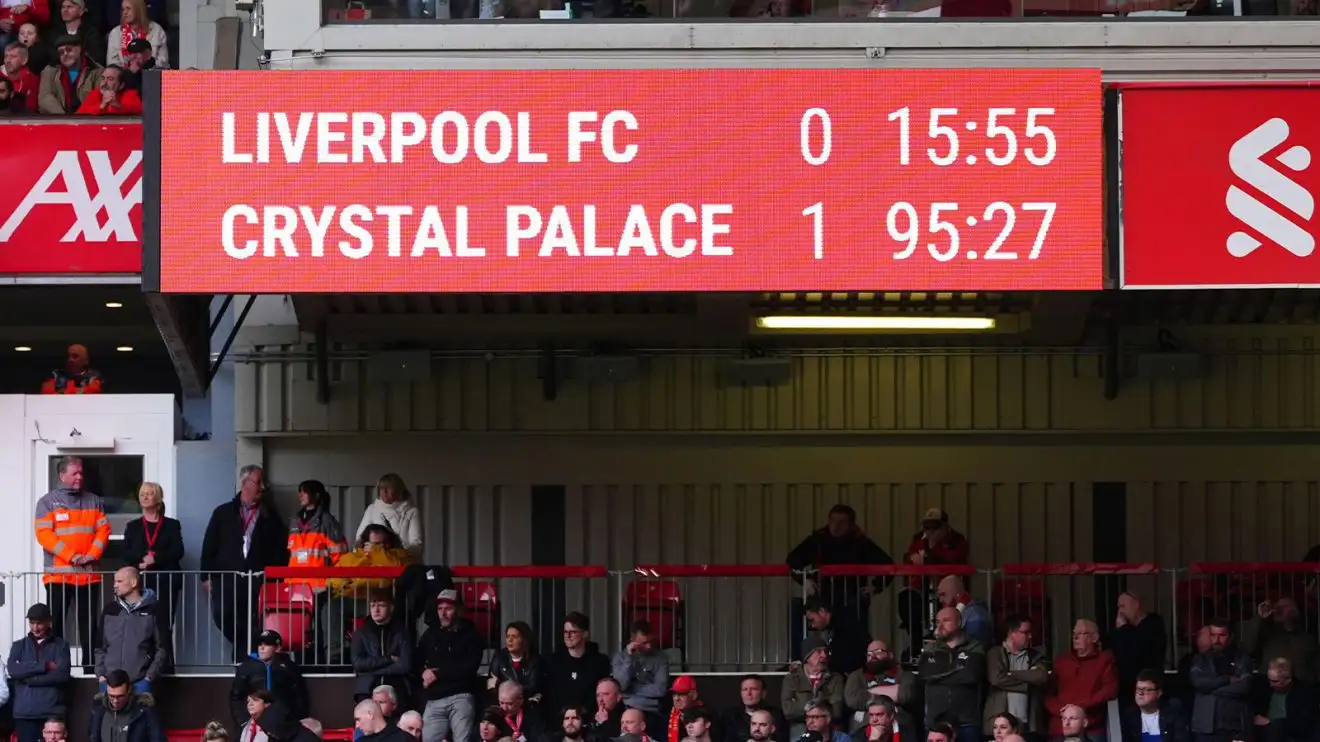 The Anfield scoreboard shows Palace a goal ahead in the dying moments of the game