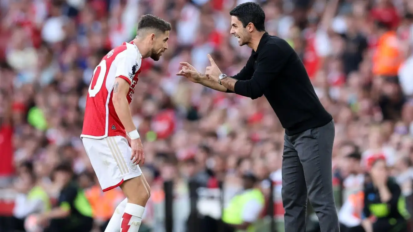 Arsenal midfielder Jorginho receives instructions from Mikel Arteta