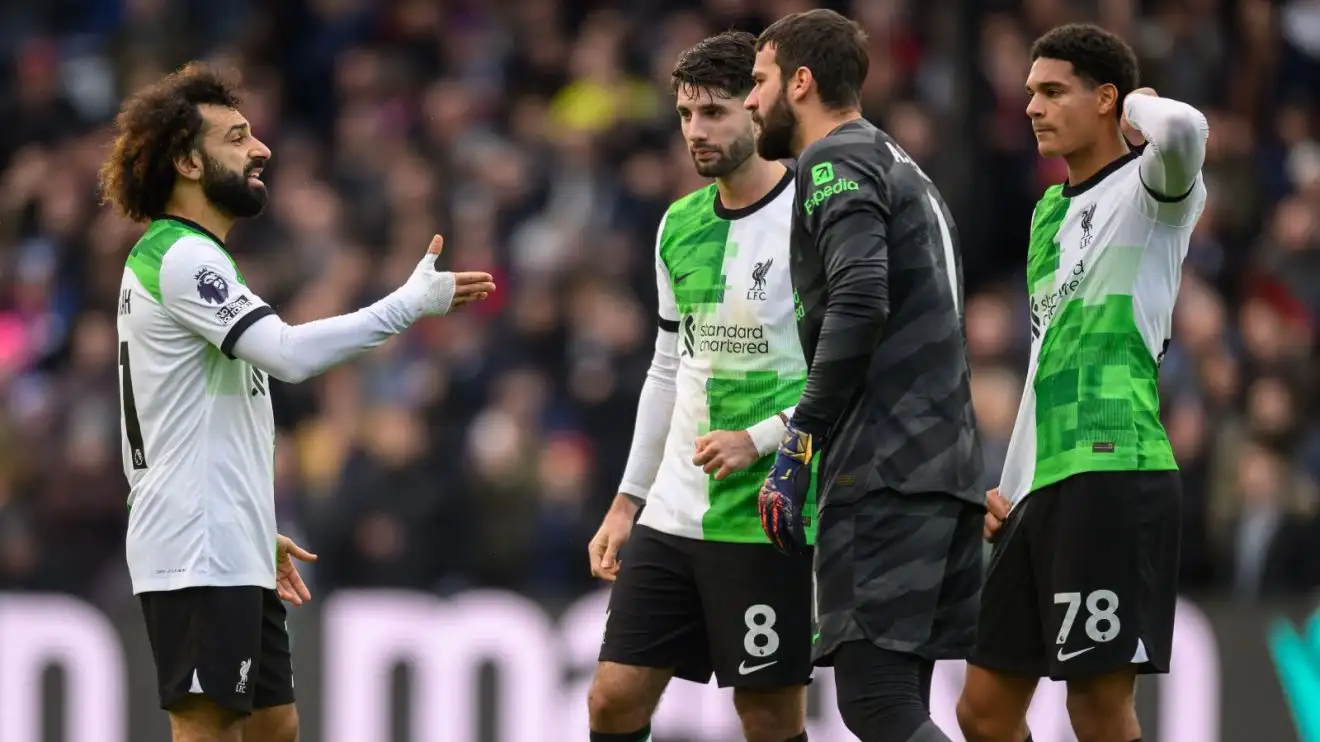 Liverpool players Mohamed Salah and Alisson in conversation during a match