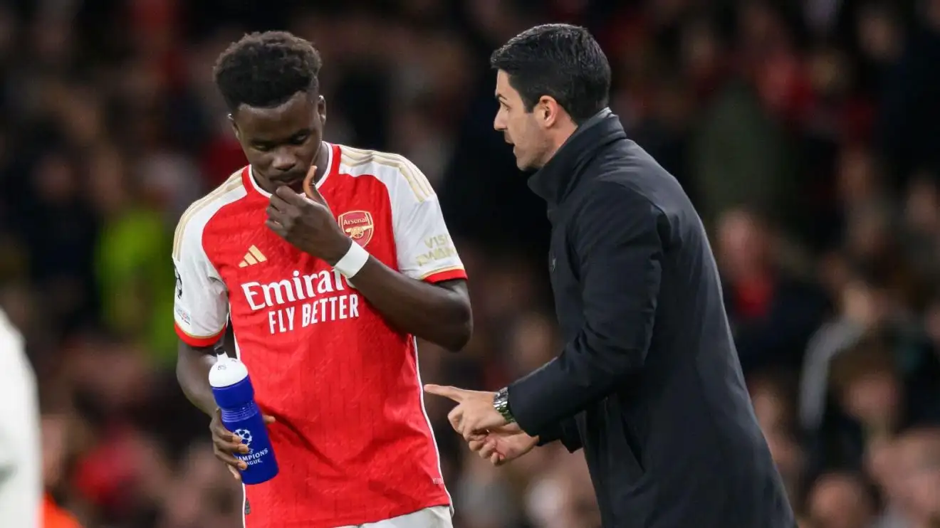 Arsenal player Bukayo Saka and boss Mikel Arteta