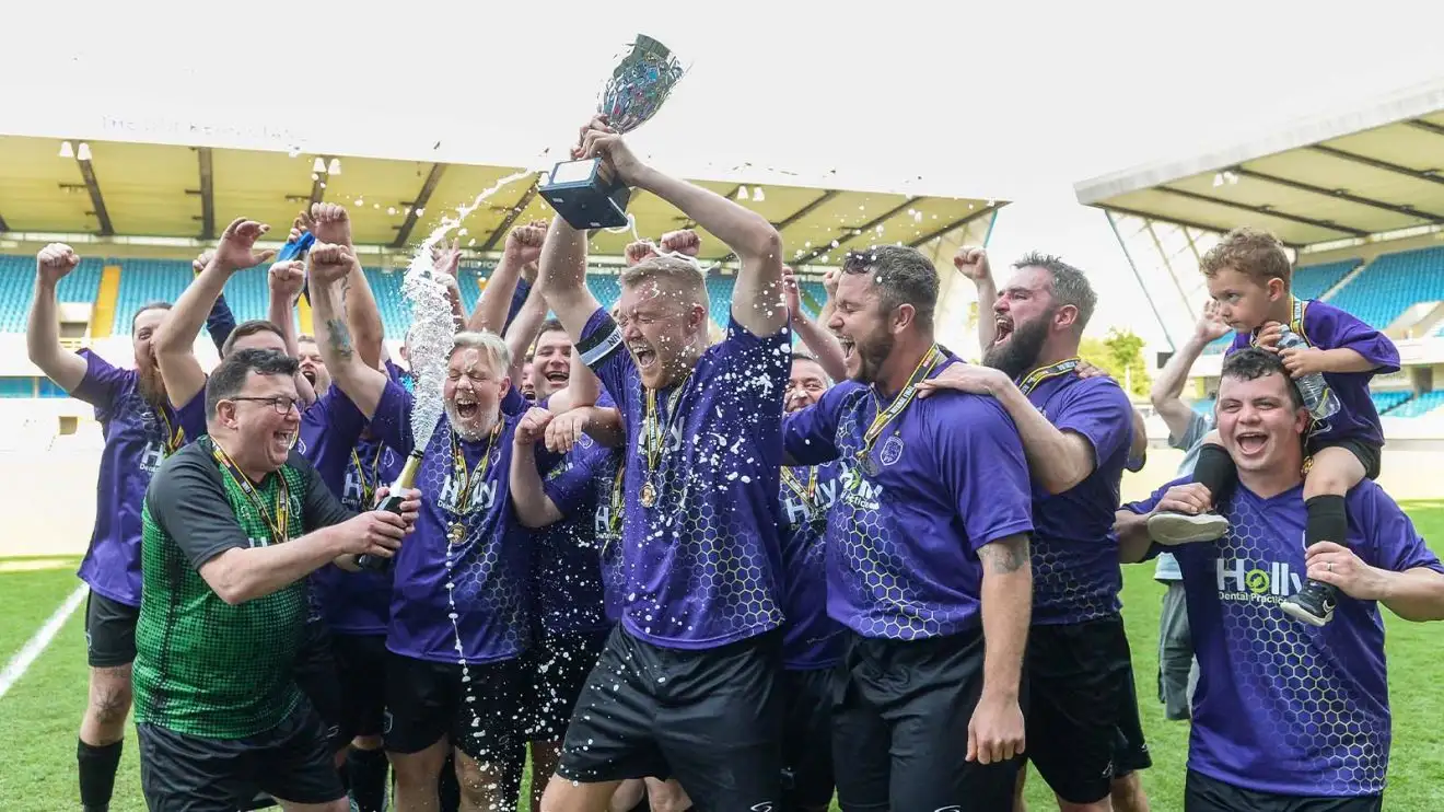 Players celebrate at the National MAN v FAT XIs final