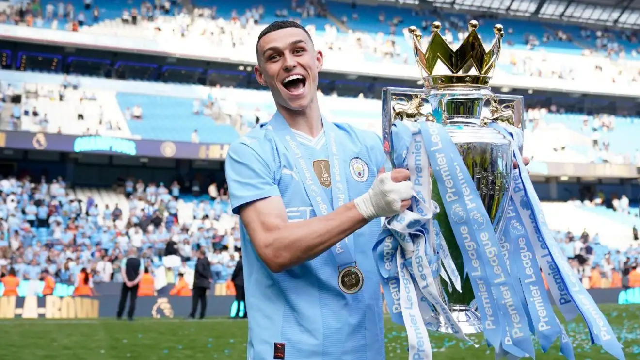 Manchester City player Phil Foden with the Premier League trophy