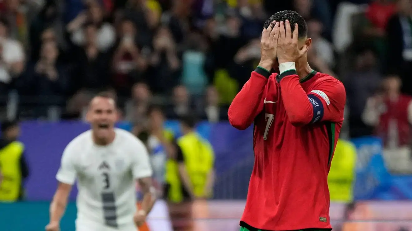 Cristiano Ronaldo holds his dismiss in his hands after lacking out on his price versus Slovenia. A Slovenian player celebrates in the background. It is awfully entertaining.