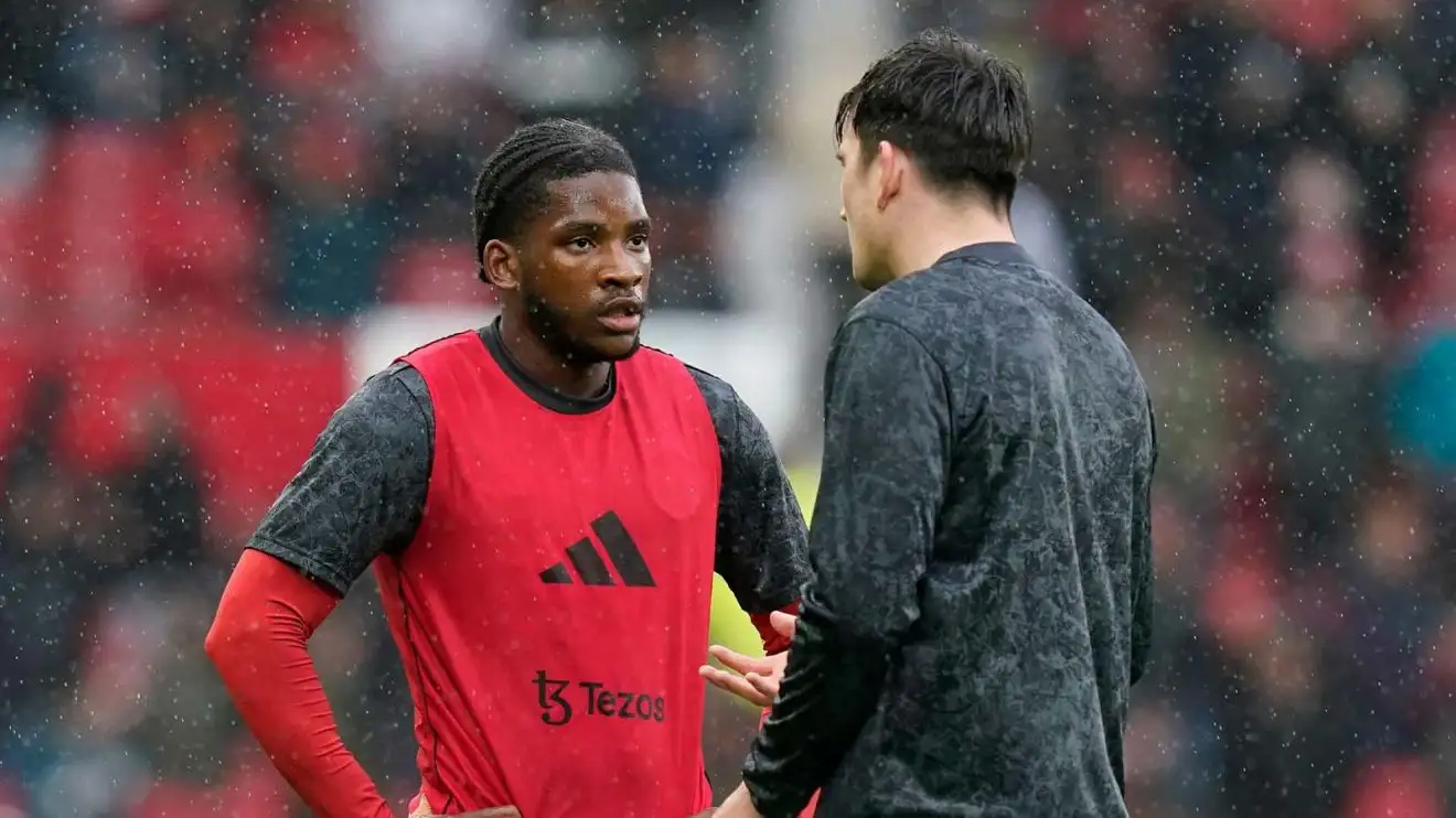 Willy Kambwala of Manchester United talks through Harry Maguire