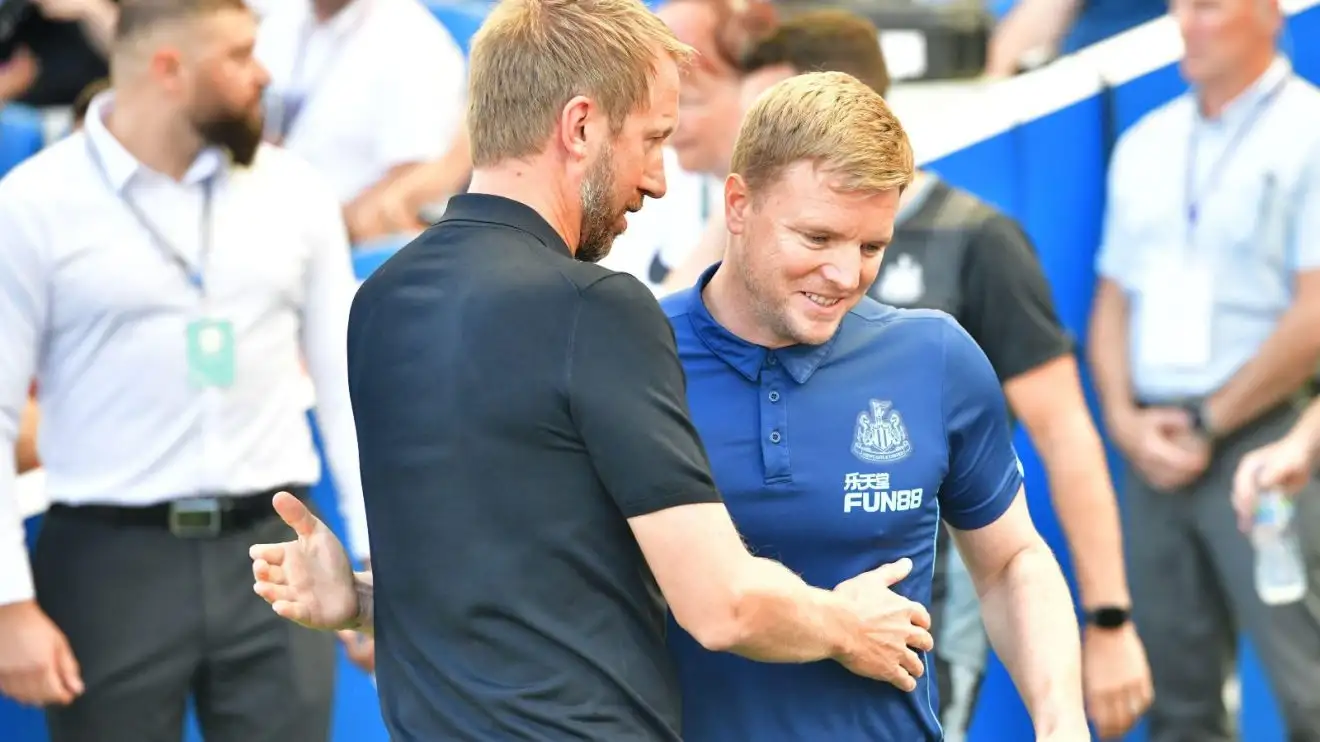 Eddie Howe is welcomed by Graham Potter before a suit