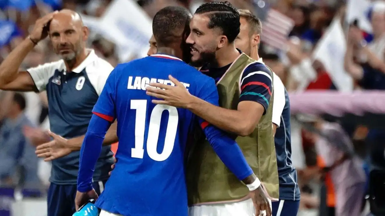 Fulham-attached onward Rayan Cherki hugs France crew-cohort Alexandre Lacazette