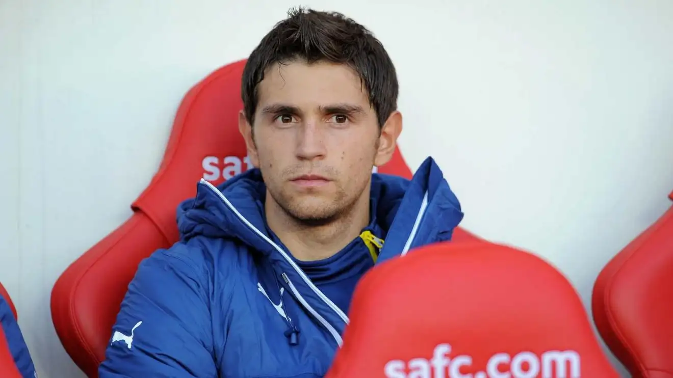 Former Arsenal goalkeeper Emiliano Martinez rests on the pew throughout a match