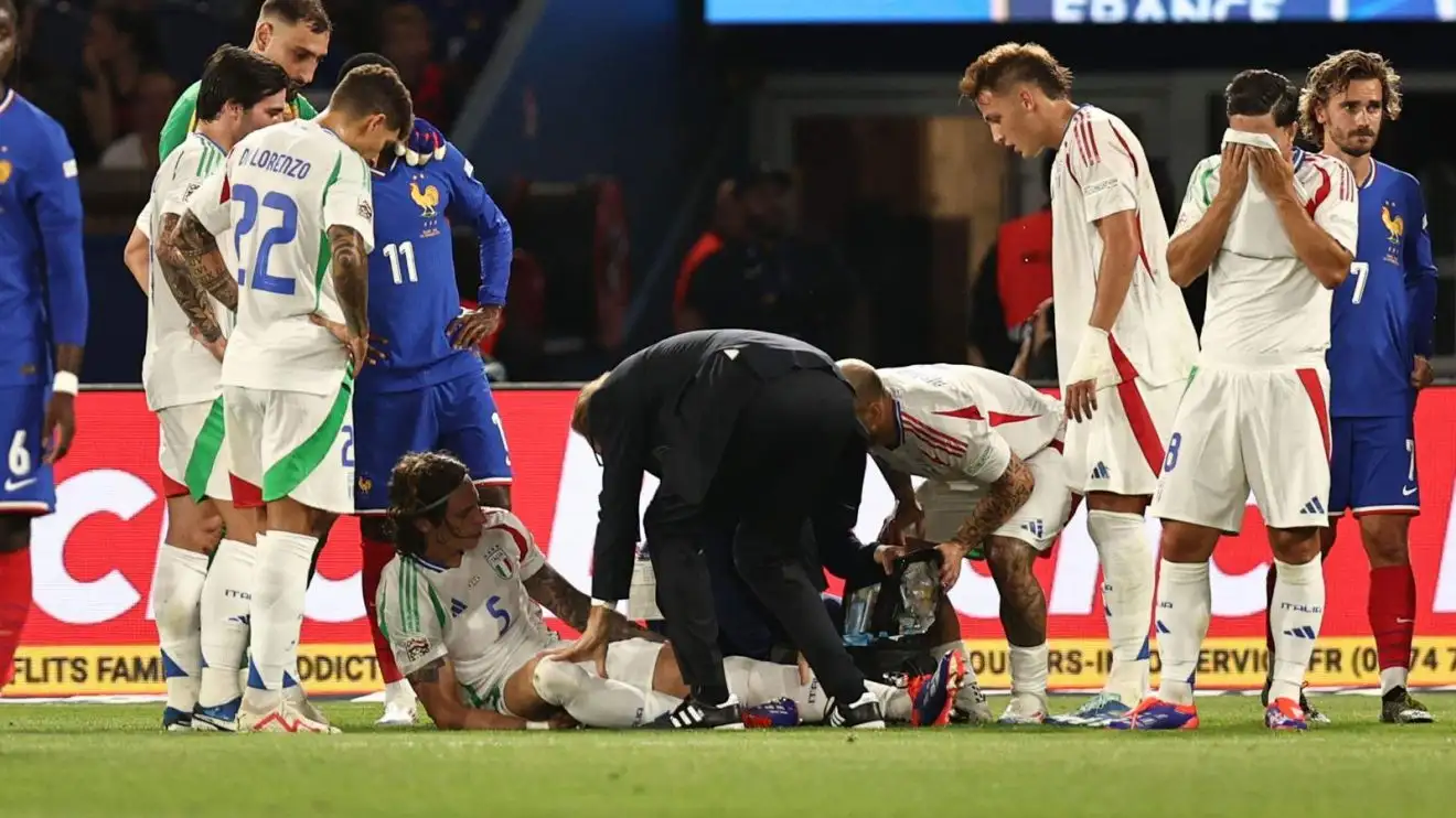 Arsenal defender Riccardo Calafiori receives treatment for an injured ankle joint throughout an Italy suit