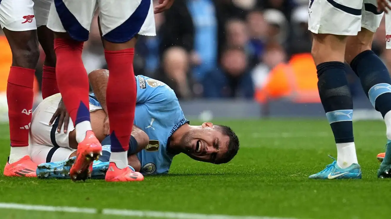 Manchester City's Rodri holds his leg in agony while playing against Arsenal