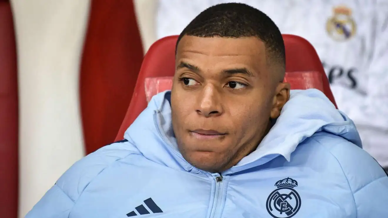 Kylian Mbappe resting on the church bench