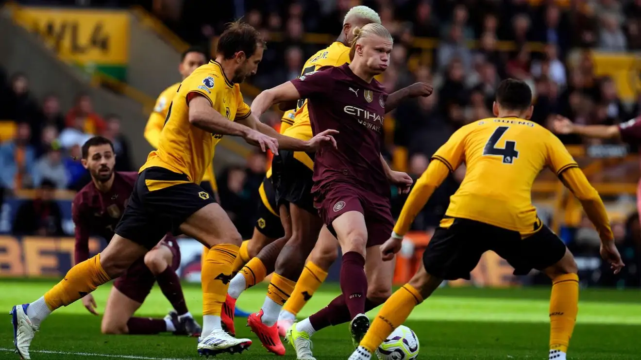 Erling Haaland, in possession by Manchester City, is swarmed by a pack of Wolves players