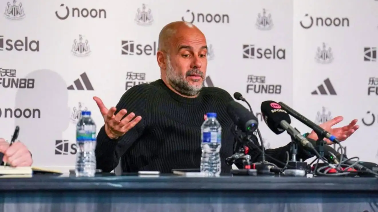 Pep Guardiola gestures throughout a press conference