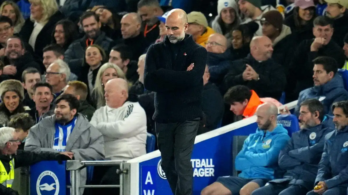 Pep Guardiola cuts a disconsolate figure on the touchline at Brighton