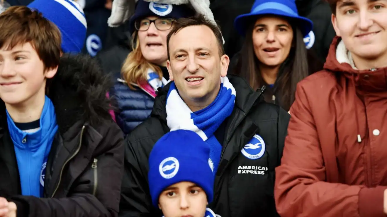 Brighton chairman Tony Blossom amongst the fans throughout a suit