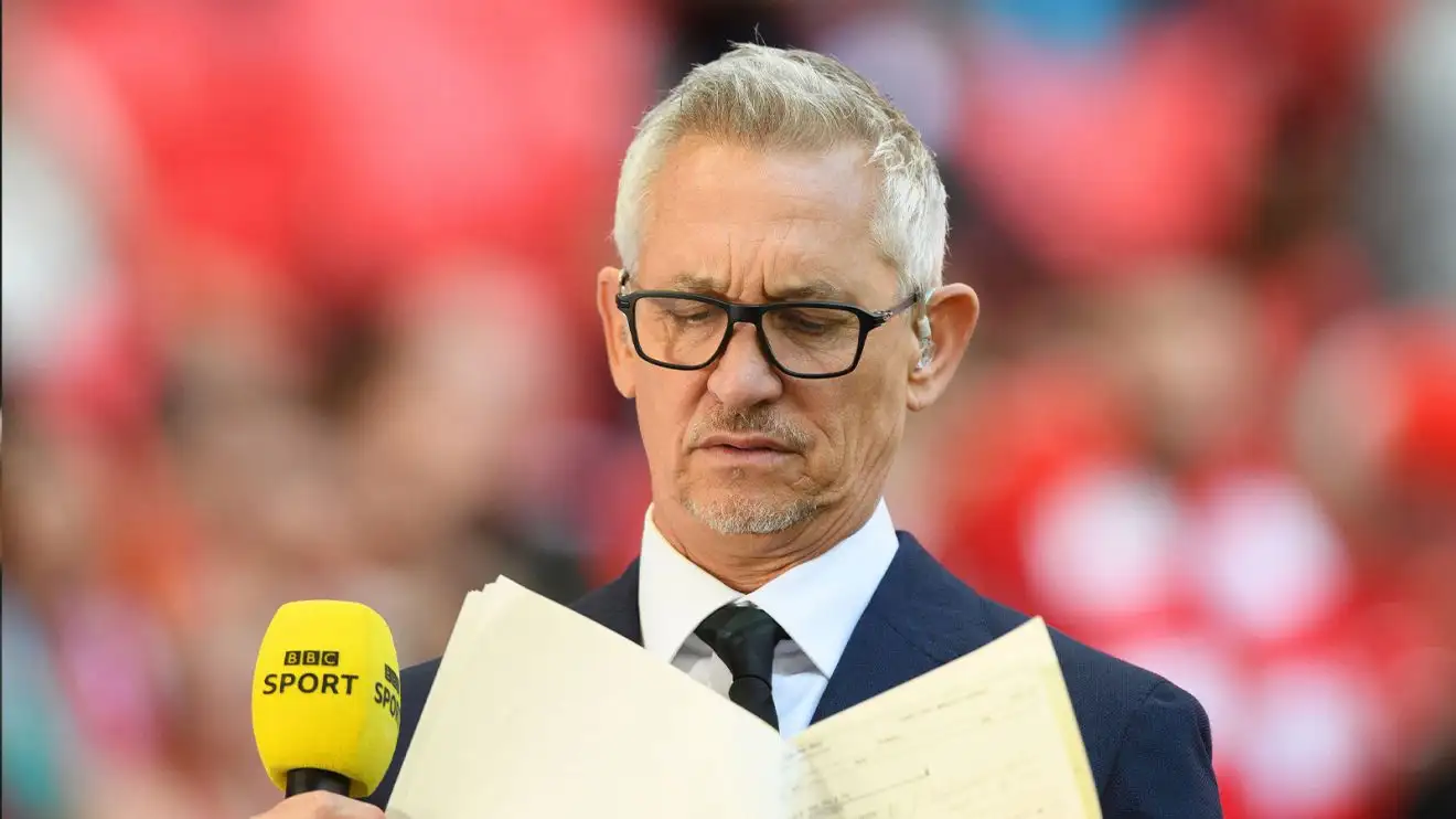Gary Lineker consults his notes at pitchside before a BBC agenda
