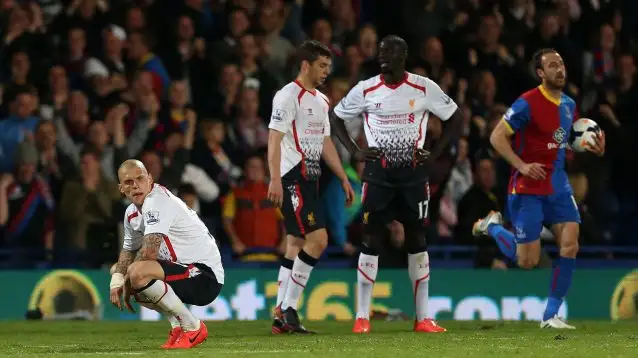 Martin Skrtel crouches dejected at Selhurst Park as Crystal Palace's Glenn Murray trots off with the ball