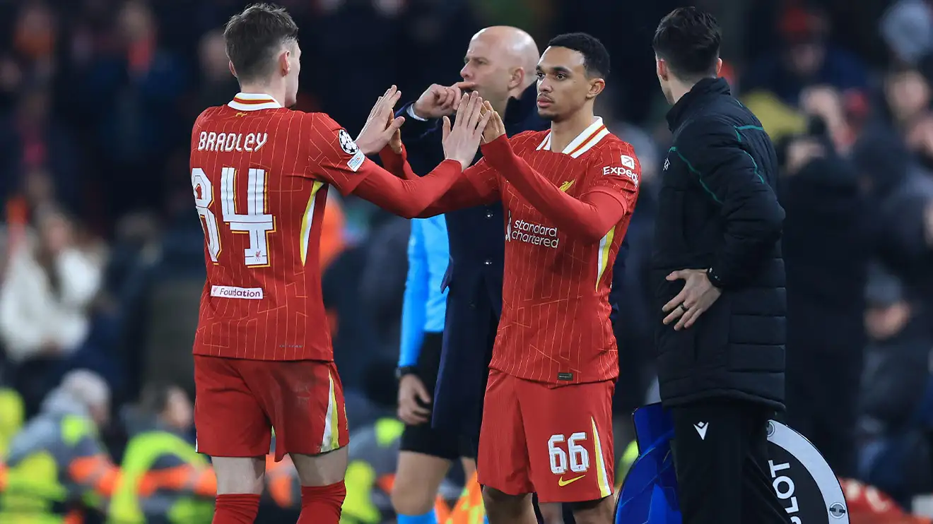 Conor Bradley gives Trent Alexander-Arnold a double high-five as he makes way in a substitution