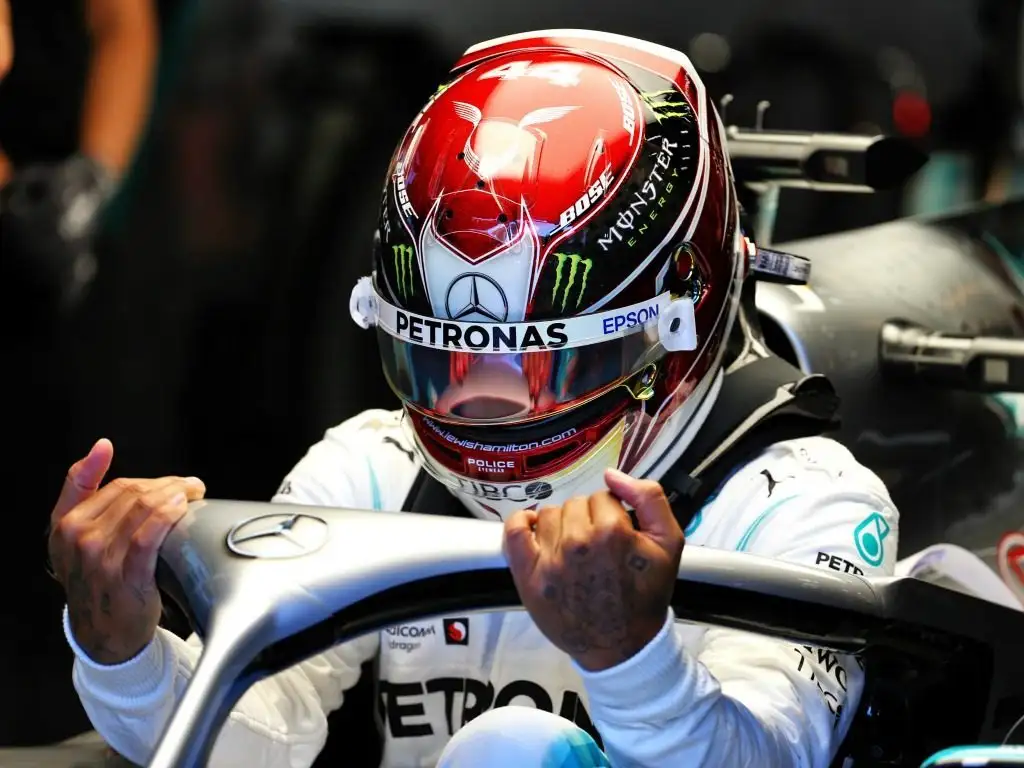 Lewis Hamilton getting into the cockpit