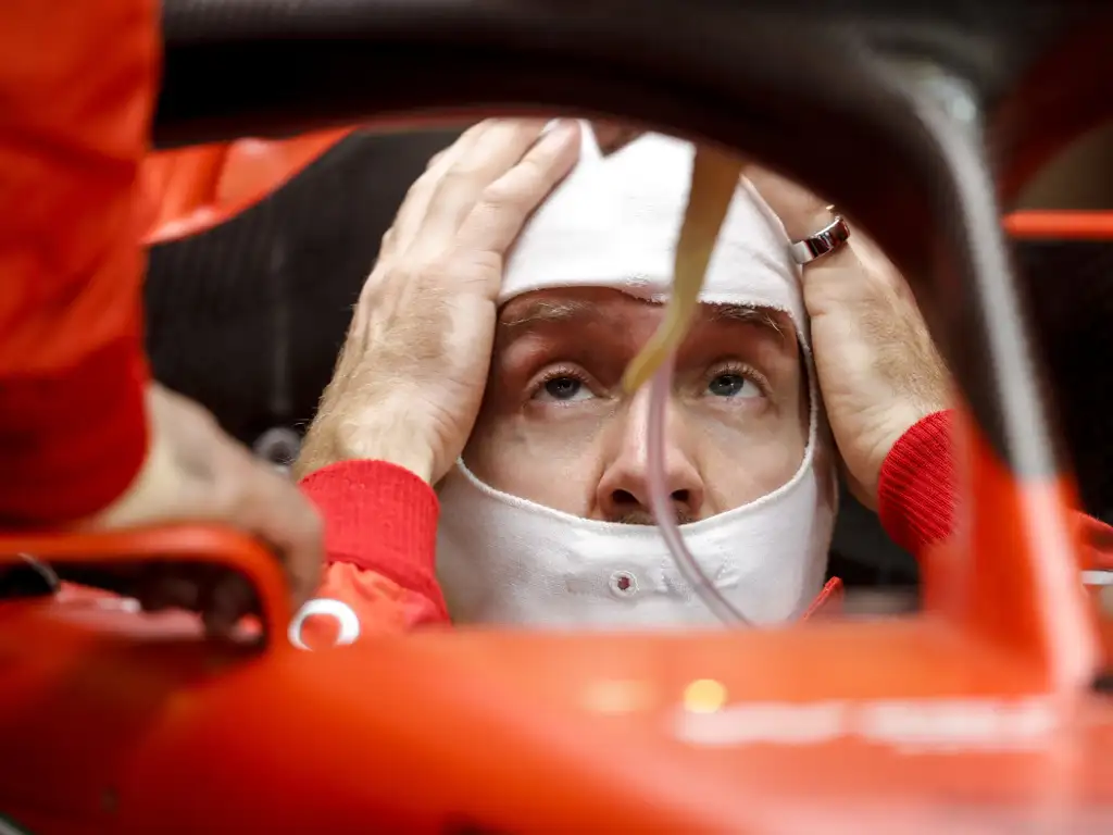 Sebastian-Vettel-head-in-hands-in-car-PA