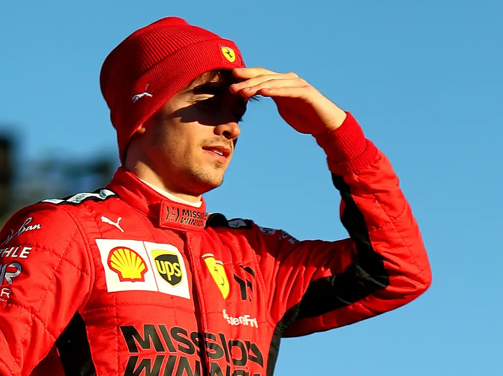 Charles Leclerc peering forward hand on forehead