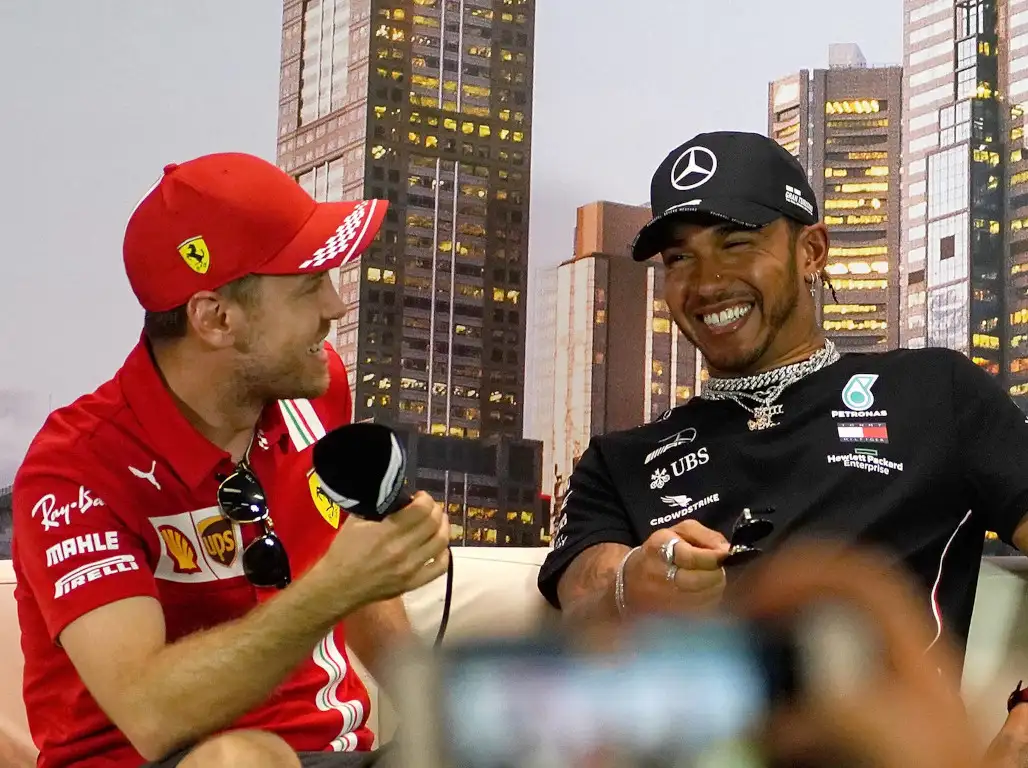 Sebastian Vettel and Lewis Hamilton smiling