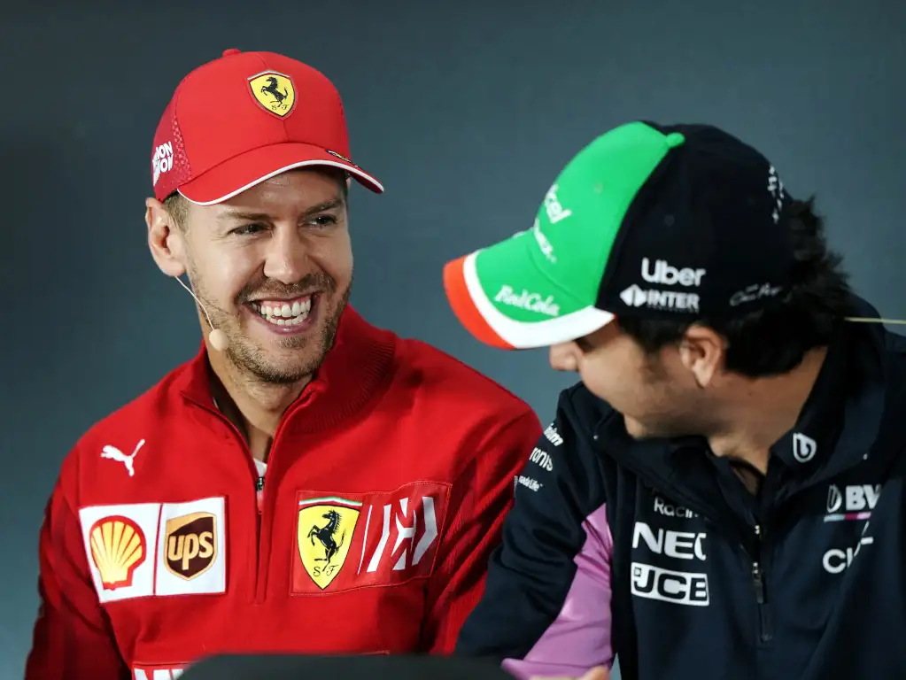 Sebastian Vettel smiling at Sergio Perez pa.jpg