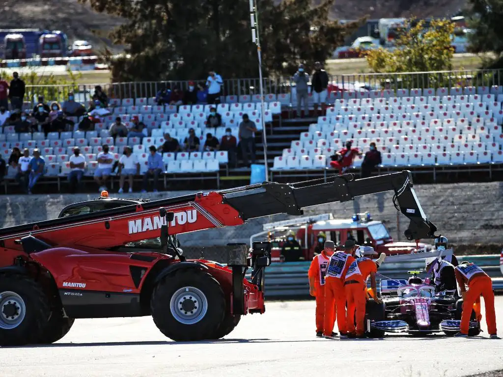 Lance Stroll's Racing Point is craned away after he spun out of FP2 for the Portuguese Grand Prix after colliding with Max Verstappen