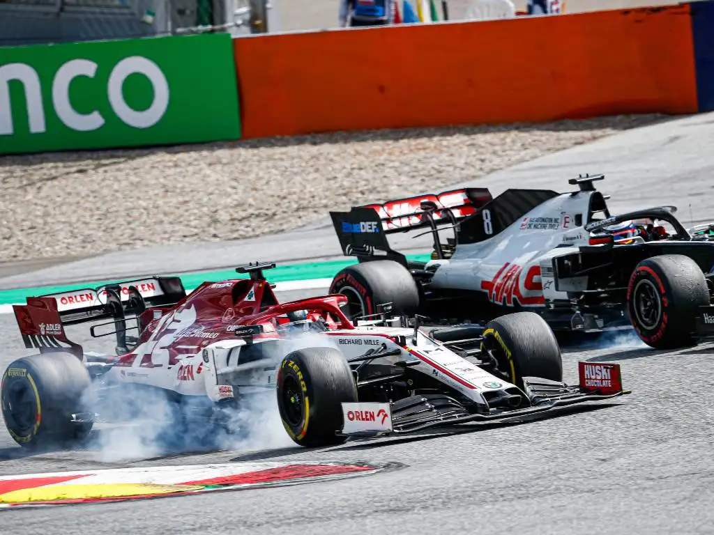 Kimi Raikkonen (Alfa Romeo) alongside Romain Grosjean (Haas)