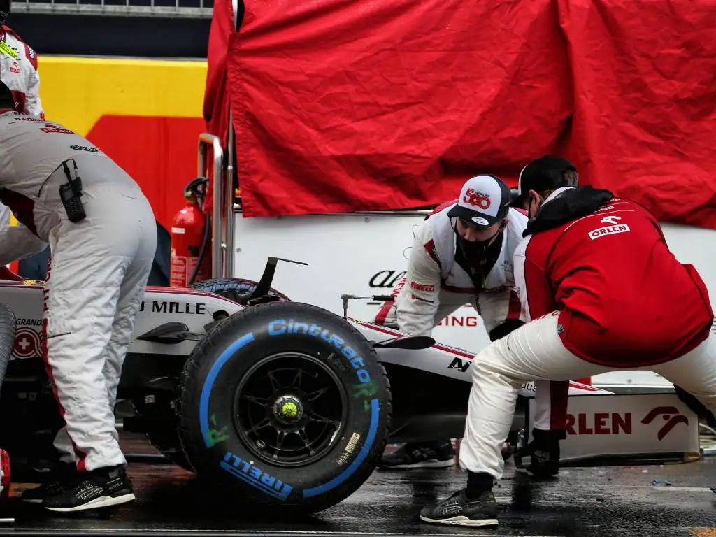 Alfa Romeo mechanics replace Antonio Giovinazzi's front wing on the grid before the Turkish Grand Prix