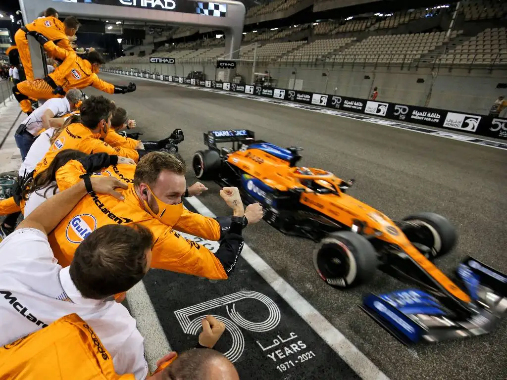 Carlos Sainz crosses the line as McLaren celebrate P3 in the constructors' World Championship