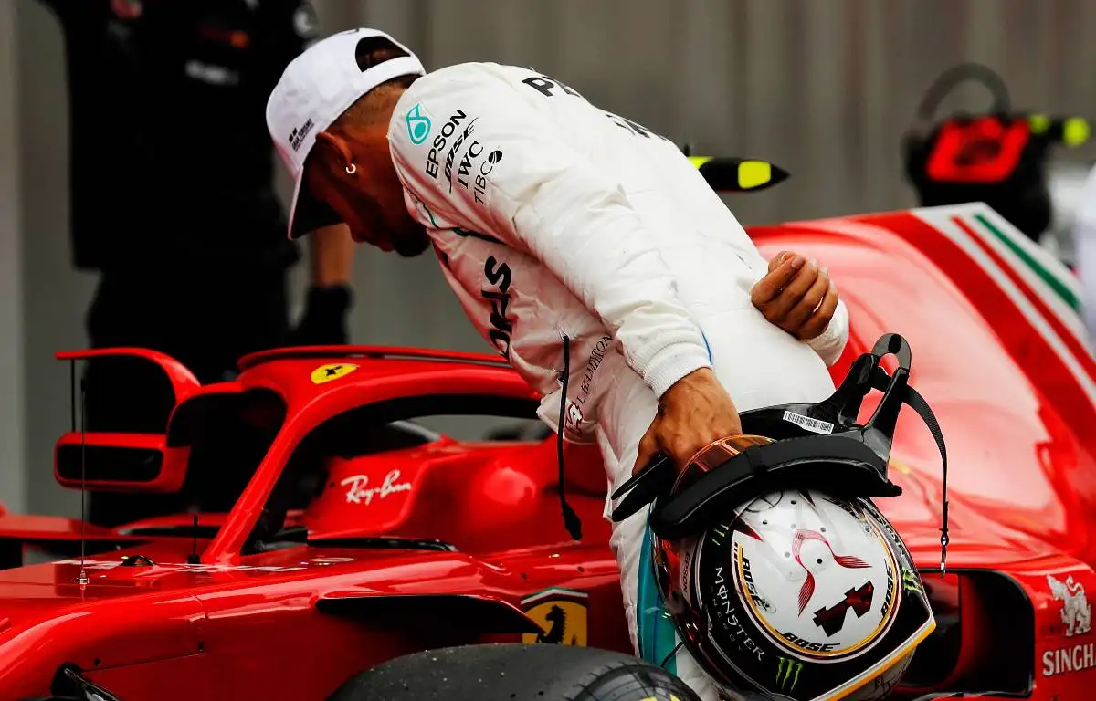 Lewis Hamilton looks at Kimi Raikkonen's Ferrari in 2018