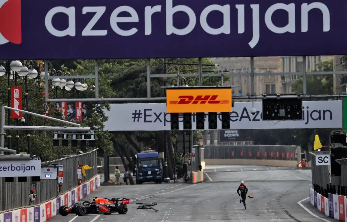 Max Verstappen runs away from his crashed Red Bull during the 2021 Azerbaijan Grand Prix