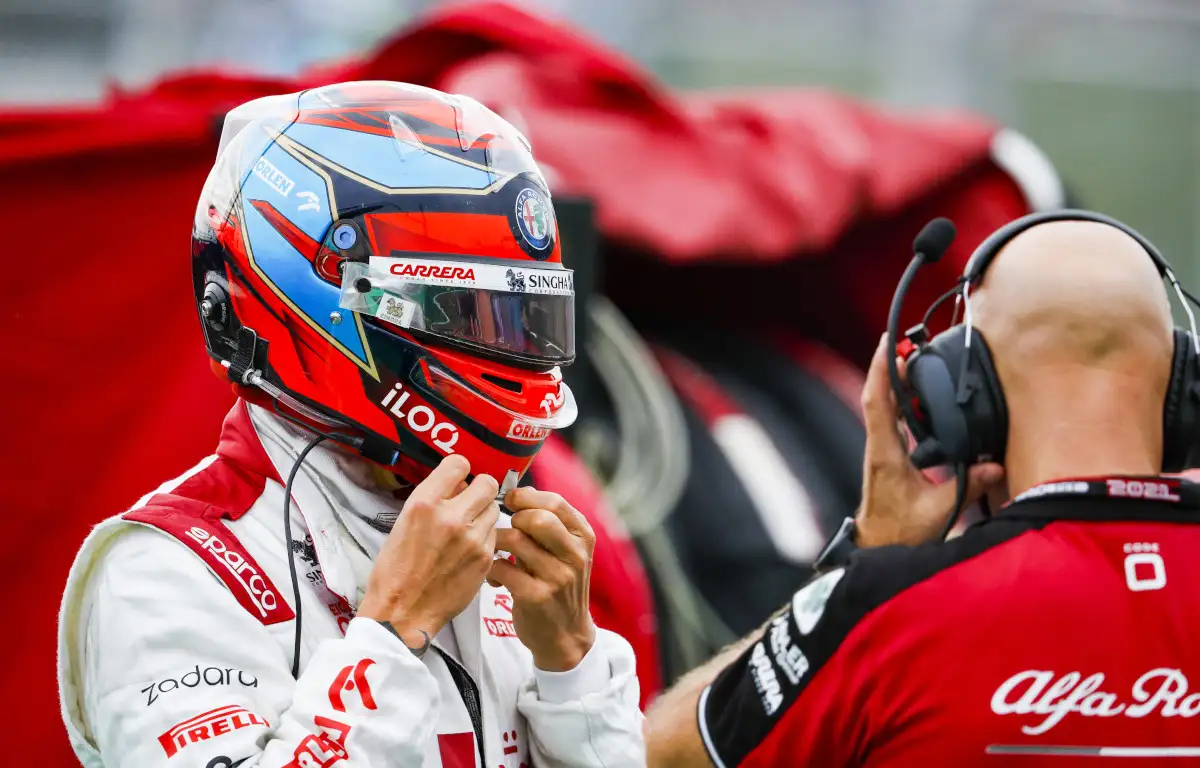 Alfa Romeo driver Kimi Raikkonen putting on his helmet. Hungary August 2021.