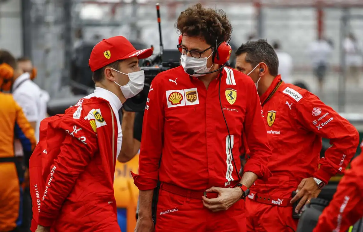 Ferrari team boss Mattia Binotto and Charles Leclerc speak on the grid.