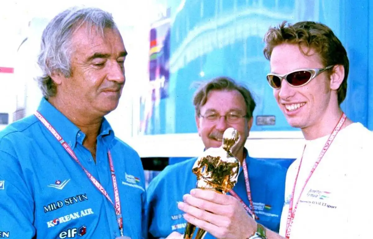 Jenson Button shows his "Bernie" Best Newcomer Award to Flavio Briatore. 2001.