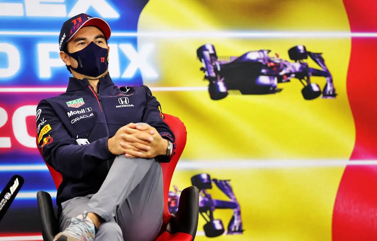 Sergio Perez [Red Bull] with his leg up in the Belgian GP press conference. August 2021.