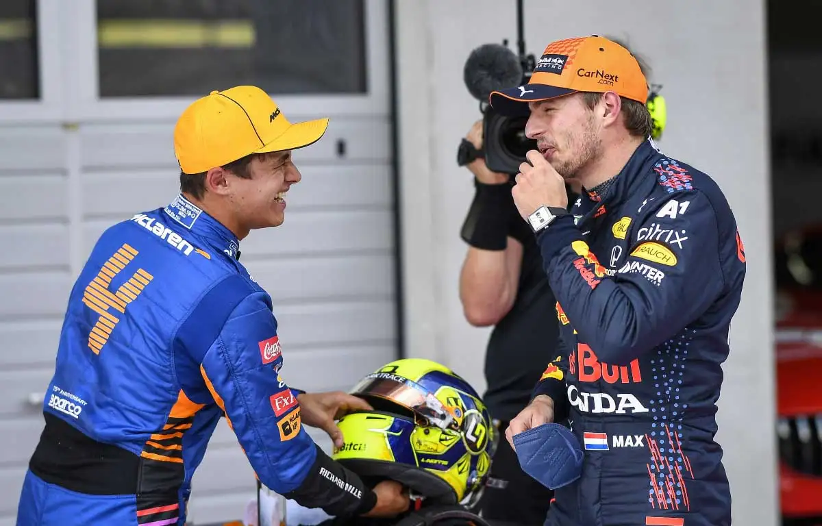 Lando Norris and Max Verstappen share a joke after a race.