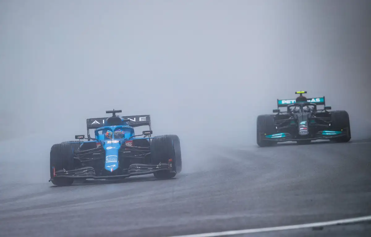 Fernando Alonso and Valtteri Bottas in the spray. Belgium, August 2021.