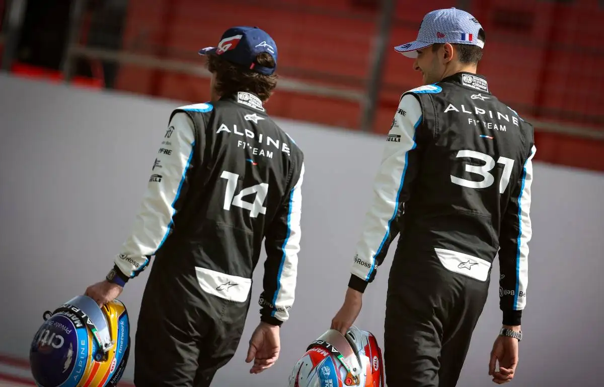 Fernando Alonso and Esteban Ocon carrying helmets at the pre-season testing photoshoot. Bahrain March 2021.