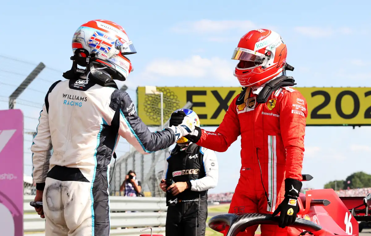 George Russell shakes hands with Charles Leclerc. Britain July 2021