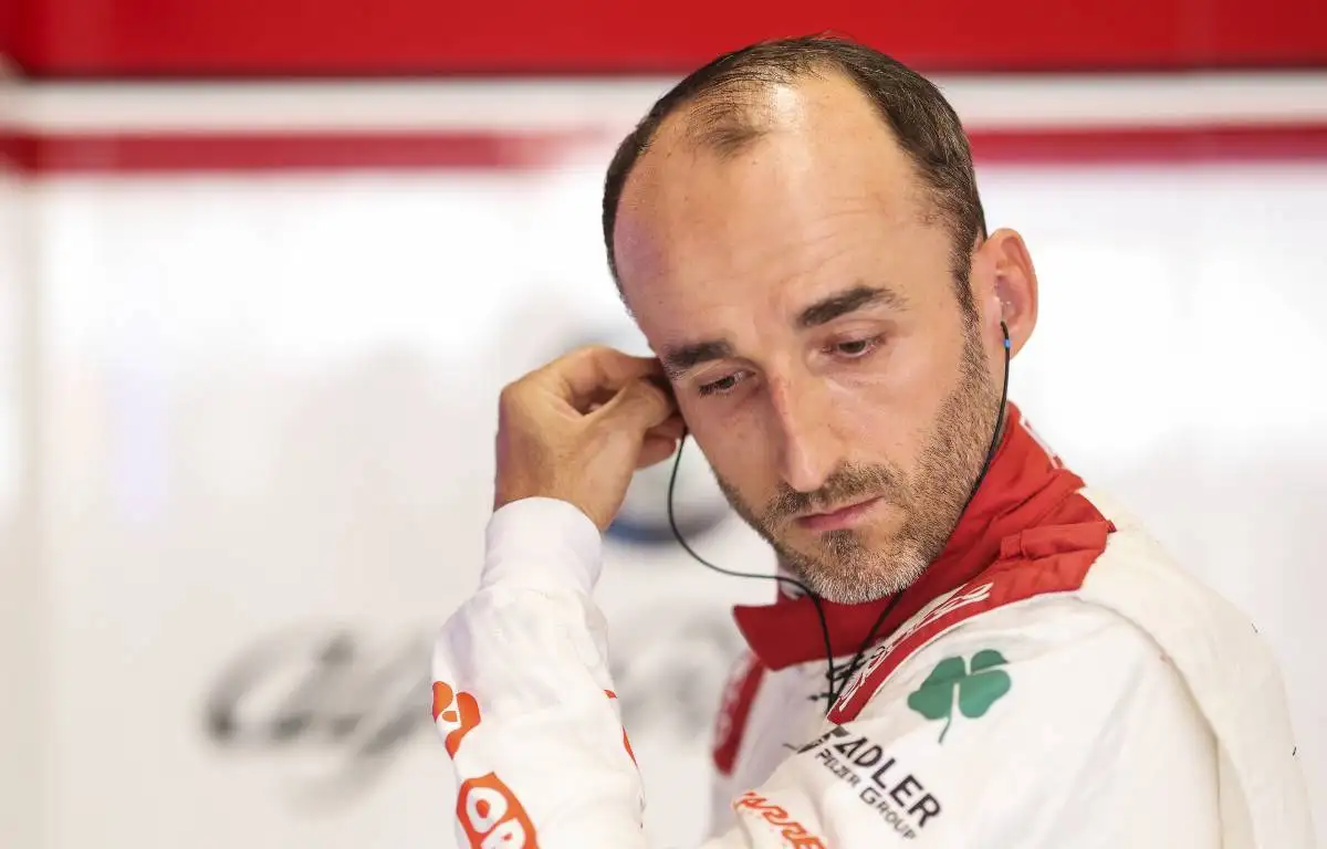 Robert Kubica touching earpiece in Alfa Romeo garage. Zandvoort September 2021.