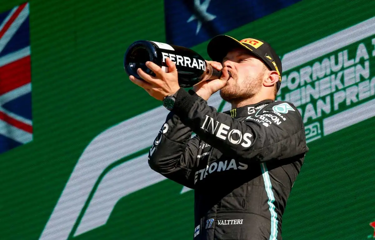 Valtteri Bottas drinks champagne on the podium at Monza. September 2021.
