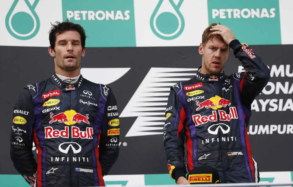 Mark Webber and Sebastian Vettel stand on the podium at Sepang in 2013.