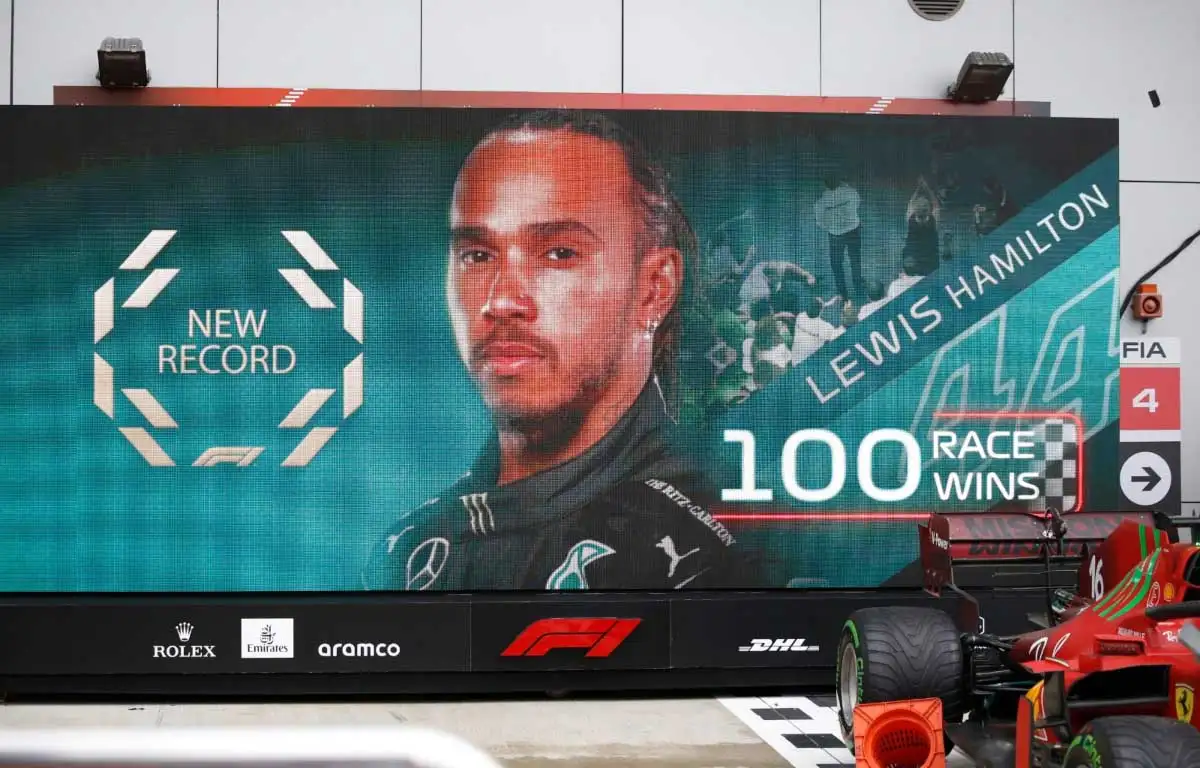 A board shows a graphic as Lewis Hamilton wins his 100th race at the Russian GP.