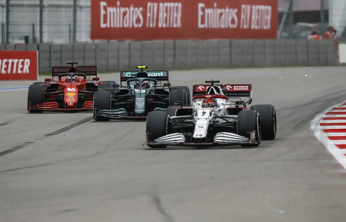 Kimi Raikkonen, Alfa Romeo, leads an Aston Martin and a Ferrari. Russia, September 2021.