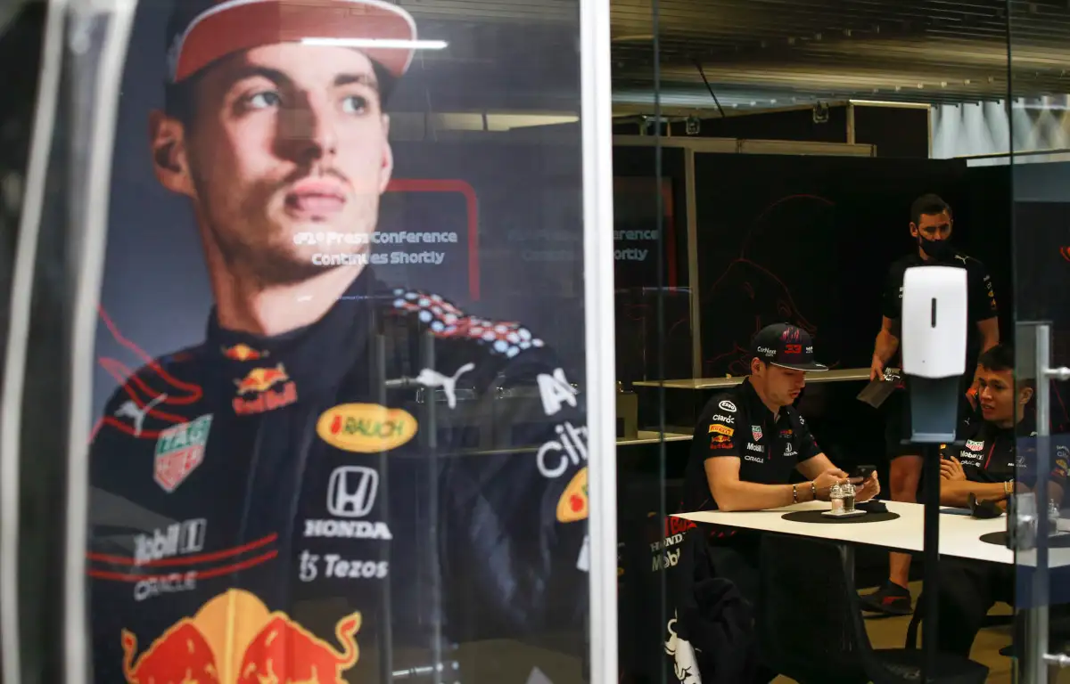 Max Verstappen sitting in the Red Bull hospitality with a giant picture of himself on the wall. Brazil November 2021
